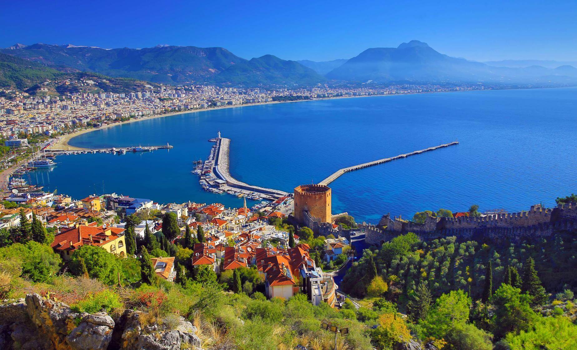 Alanya Day Trip 2 Tourists enjoying a scenic boat trip along the Alanya coastline with Alanya Castle visible in the background