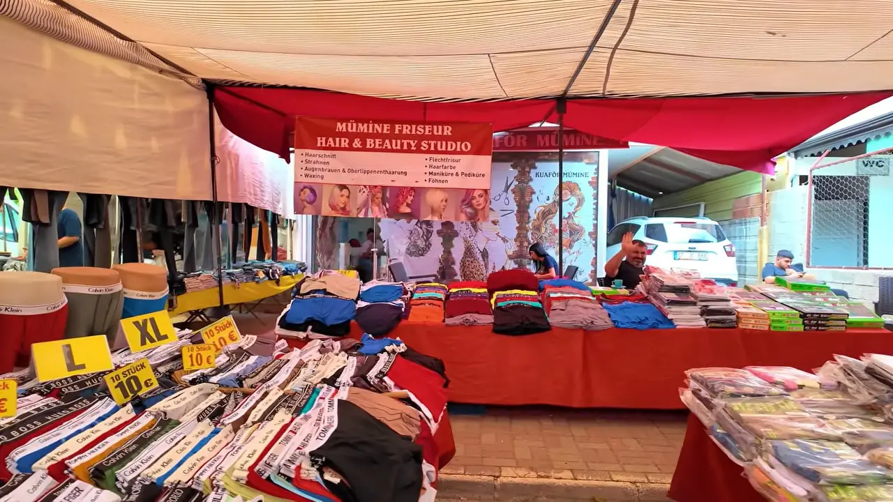 Colorful stalls at Manavgat Monday Bazaar showing textiles spices and leather goods